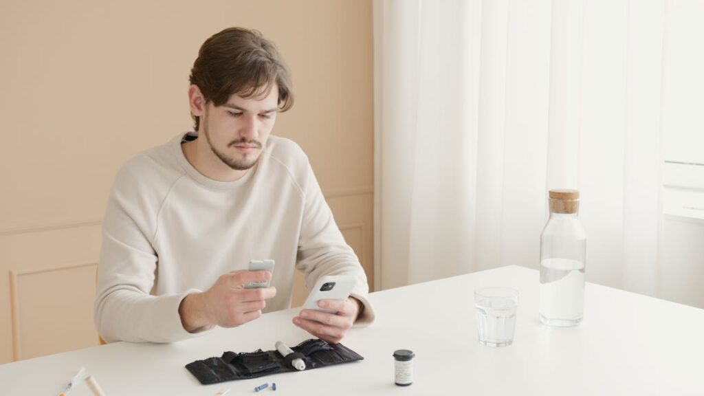 pexels photo 6823493 A young man checks his blood glucose level using a glucometer at home.