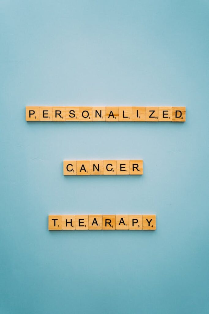 pexels photo 8428414 Scrabble tiles on blue background spelling 'Personalized Cancer Therapy'.